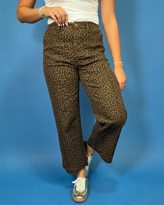 Brown leopard print high-rise pants with a flattering wide-leg silhouette, cropped length, and convenient side pockets.