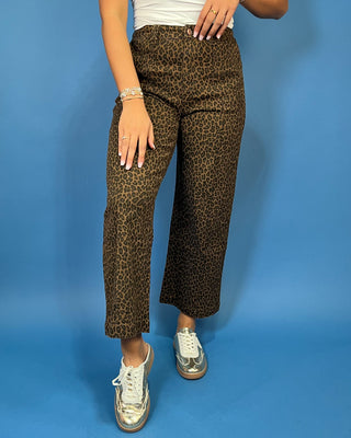 Brown leopard print high-rise pants with a flattering wide-leg silhouette, cropped length, and convenient side pockets.