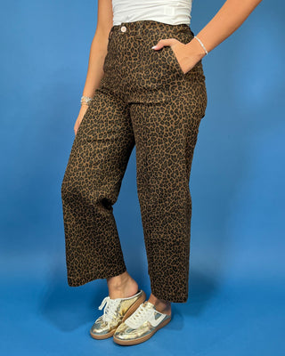 Brown leopard print high-rise pants with a flattering wide-leg silhouette, cropped length, and convenient side pockets.