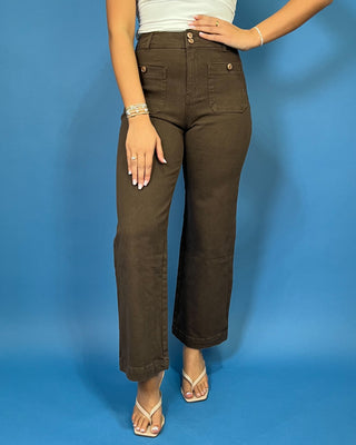 Chocolate brown high-rise wide leg pants with gold button details, front patch pockets, and a flattering cropped silhouette.