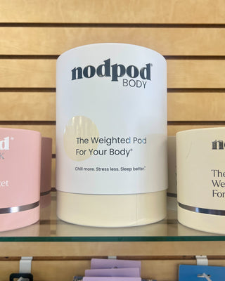 Nodpod weighted pod for sale on a shelf with a wooden background