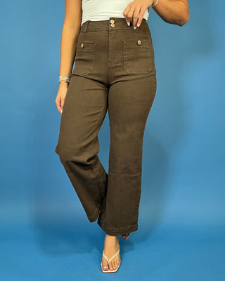 Chocolate brown high-rise wide leg pants with gold button details, front patch pockets, and a flattering cropped silhouette.