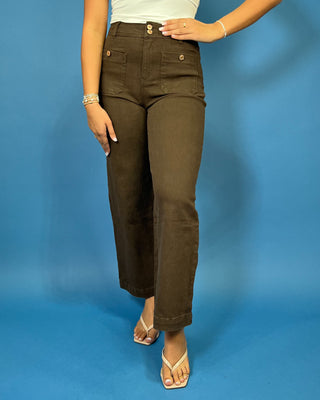 Chocolate brown high-rise wide leg pants with gold button details, front patch pockets, and a flattering cropped silhouette.