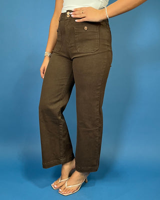 Chocolate brown high-rise wide leg pants with gold button details, front patch pockets, and a flattering cropped silhouette.