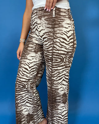 Brown and cream zebra print high-rise pants with a wide-leg silhouette, cropped length, and bold allover animal print.
