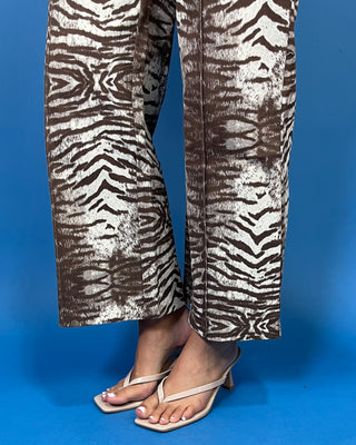 Brown and cream zebra print high-rise pants with a wide-leg silhouette, cropped length, and bold allover animal print.