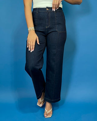 Dark wash high-rise wide leg jeans with front patch pockets, flattering seam details, and a cropped ankle-length silhouette.
