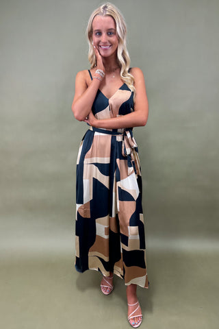 Woman wearing a patterned dress against a plain background