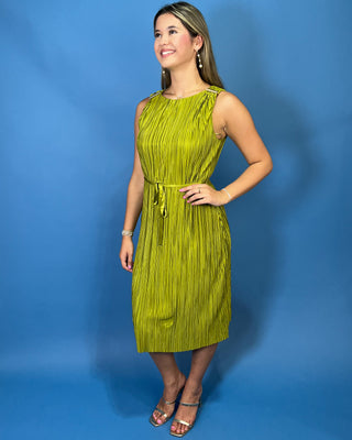 A woman modeling a sleeveless olive green pleated midi dress with a tie waist