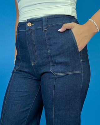 Dark wash high-rise wide leg jeans with front patch pockets, flattering seam details, and a cropped ankle-length silhouette.