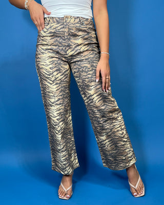 Tan and black tiger print high-rise wide leg jeans with a bold allover animal print and flattering cropped length.