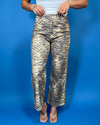Tan and black tiger print high-rise wide leg jeans with a bold allover animal print and flattering cropped length.