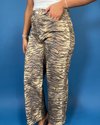 Tan and black tiger print high-rise wide leg jeans with a bold allover animal print and flattering cropped length.