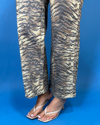 Tan and black tiger print high-rise wide leg jeans with a bold allover animal print and flattering cropped length.