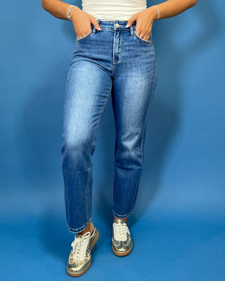 Medium wash high-rise straight leg jeans with subtle fading, a clean hem, classic five-pocket styling, and an ankle-length fit.