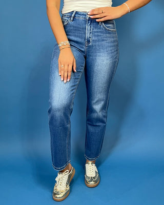 Medium wash high-rise straight leg jeans with subtle fading, a clean hem, classic five-pocket styling, and an ankle-length fit.