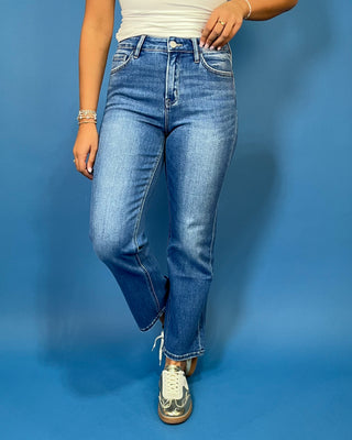 Medium wash high-rise straight leg jeans with subtle fading, a clean hem, classic five-pocket styling, and an ankle-length fit.