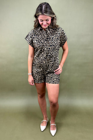 Woman wearing a leopard print outfit against a green background