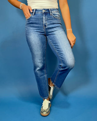 Medium wash high-rise straight leg jeans with subtle fading, a clean hem, classic five-pocket styling, and an ankle-length fit.