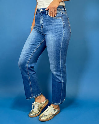 Medium wash high-rise straight leg jeans with subtle fading, a clean hem, classic five-pocket styling, and an ankle-length fit.