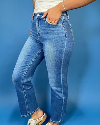 Medium wash high-rise straight leg jeans with subtle fading, a clean hem, classic five-pocket styling, and an ankle-length fit.