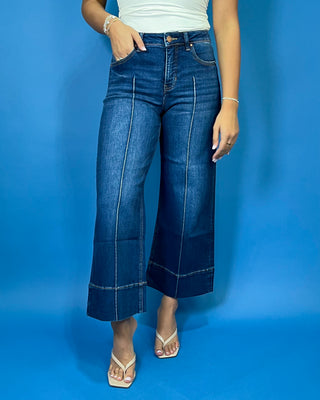 Dark wash high-rise cropped wide leg jeans with statement front seam detailing, subtle fading, and a wide cuffed hem.