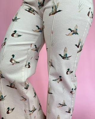 Light-colored pants with duck pattern on a pink background