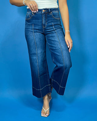 Dark wash high-rise cropped wide leg jeans with statement front seam detailing, subtle fading, and a wide cuffed hem.