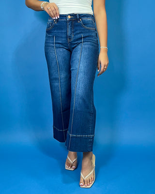 Dark wash high-rise cropped wide leg jeans with statement front seam detailing, subtle fading, and a wide cuffed hem.