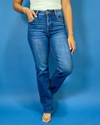 Medium-to-dark wash high-rise straight leg jeans with subtle fading, a clean finish, classic five-pocket styling, and a full-length silhouette.