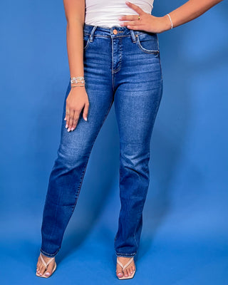 Medium-to-dark wash high-rise straight leg jeans with subtle fading, a clean finish, classic five-pocket styling, and a full-length silhouette.