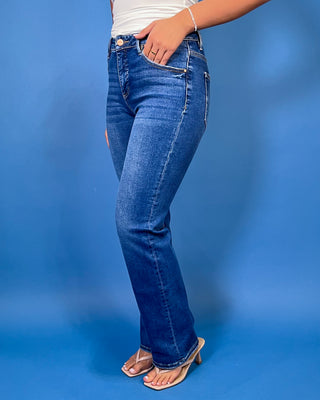 Medium-to-dark wash high-rise straight leg jeans with subtle fading, a clean finish, classic five-pocket styling, and a full-length silhouette.