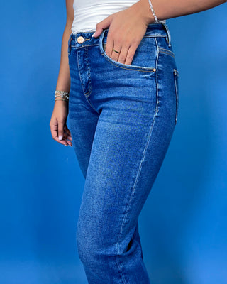 Medium-to-dark wash high-rise straight leg jeans with subtle fading, a clean finish, classic five-pocket styling, and a full-length silhouette.