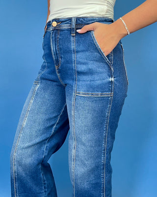 Dark wash high-rise cropped wide leg jeans with contrast front seam detailing, subtle fading, utility-inspired front pockets, and a wide cuffed hem.