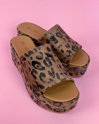 Leopard print sandals on a pink background