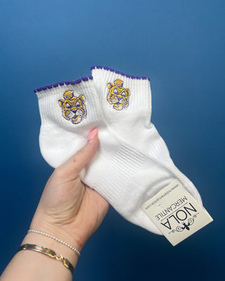White LSU ankle socks with purple scalloped trim and an embroidered LSU Tiger logo, featuring a soft knit fabric and ribbed cuff for comfortable everyday wear.