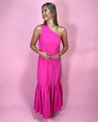 Woman wearing a pink one-shoulder dress against a pink background