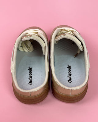 Pair of Outwoods shoes on a pink background