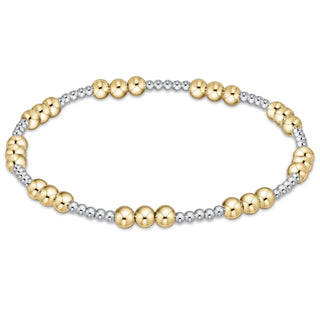 Two-tone gold and silver beaded bracelet on a white background