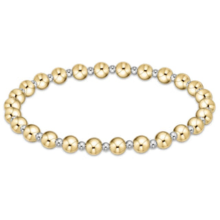 Gold and silver beaded bracelet on a white background