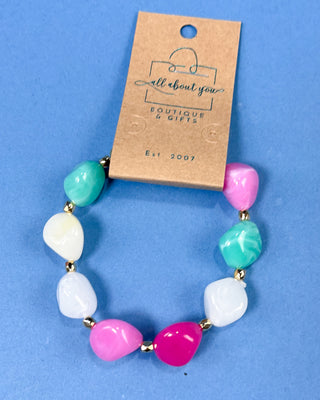 Pastel chunky marbled plastic beaded stretch bracelet with gold-tone spacer beads for women.