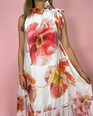 Woman wearing a floral dress with a pink background