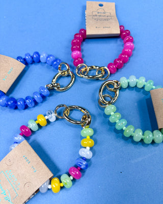 Four beaded stretch bracelets with gold-tone lobster clasp ends