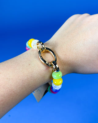 A gold-tone chain bracelet with colorful translucent beads