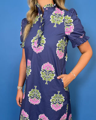 a navy blue dress with pink and green block-print floral motifs