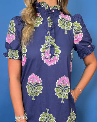a navy blue dress with pink and green block-print floral motifs