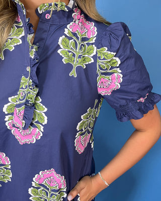 a navy blue dress with pink and green block-print floral motifs