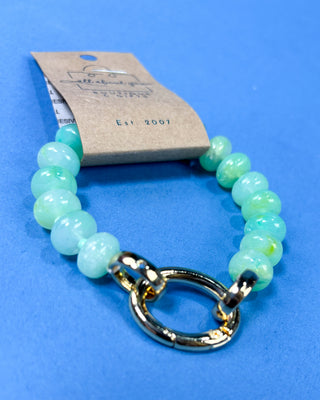 A beaded bracelet made of light green jade-like round beads 