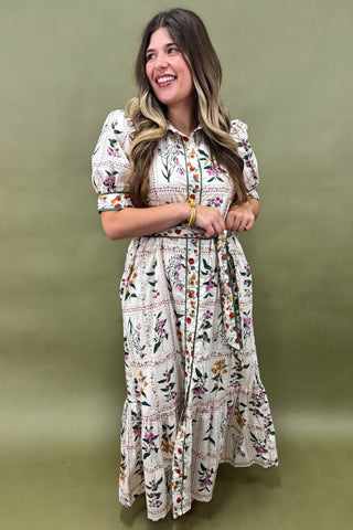 Woman wearing a floral dress against a green background