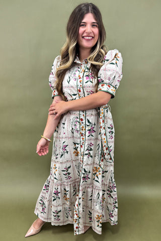 Woman wearing a floral dress against a green background